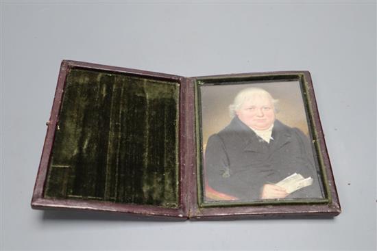A mid 19th century portrait miniature of a seated gentleman, in folding frame, height 11cm